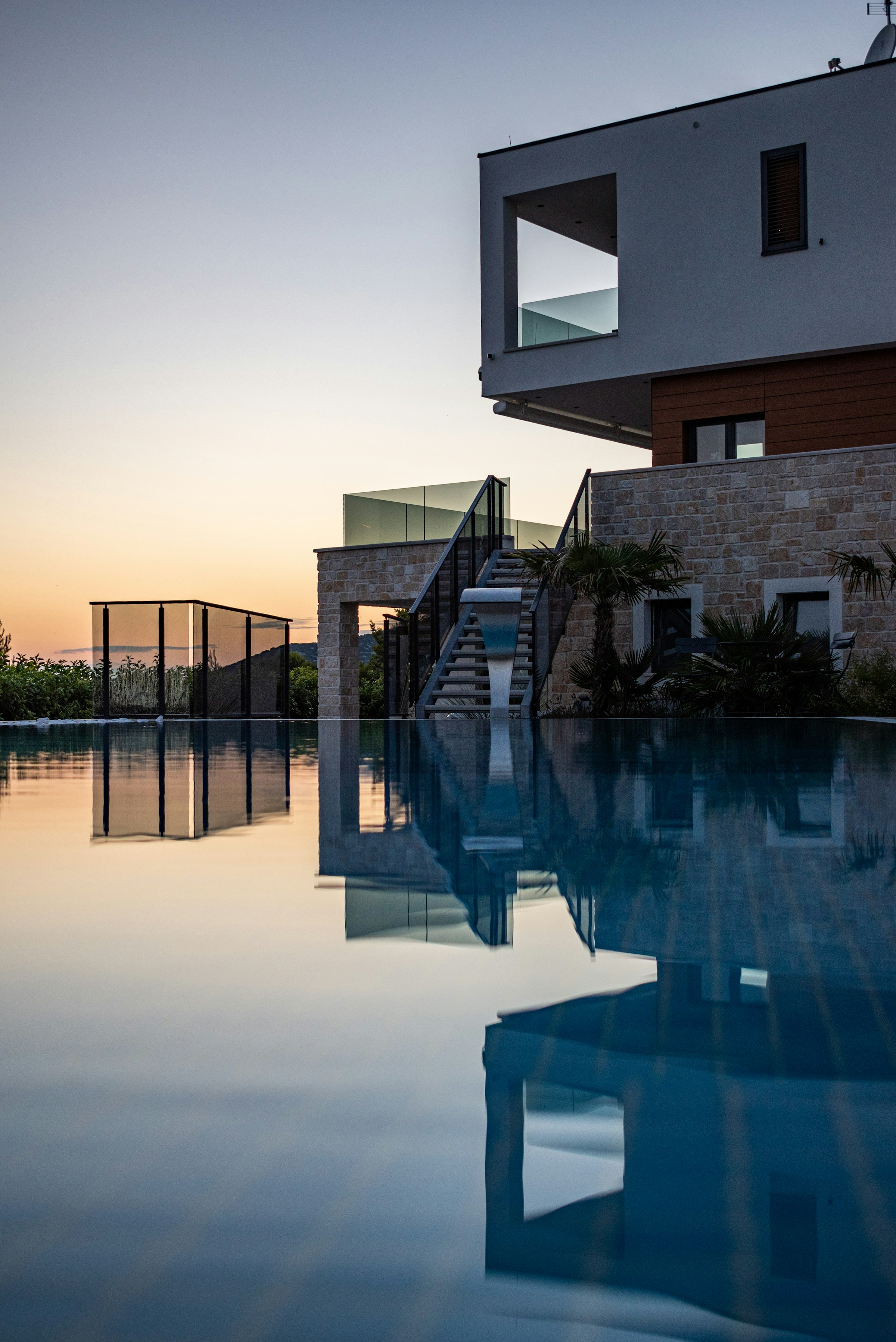Unity branded residence at dusk with reflecting pool