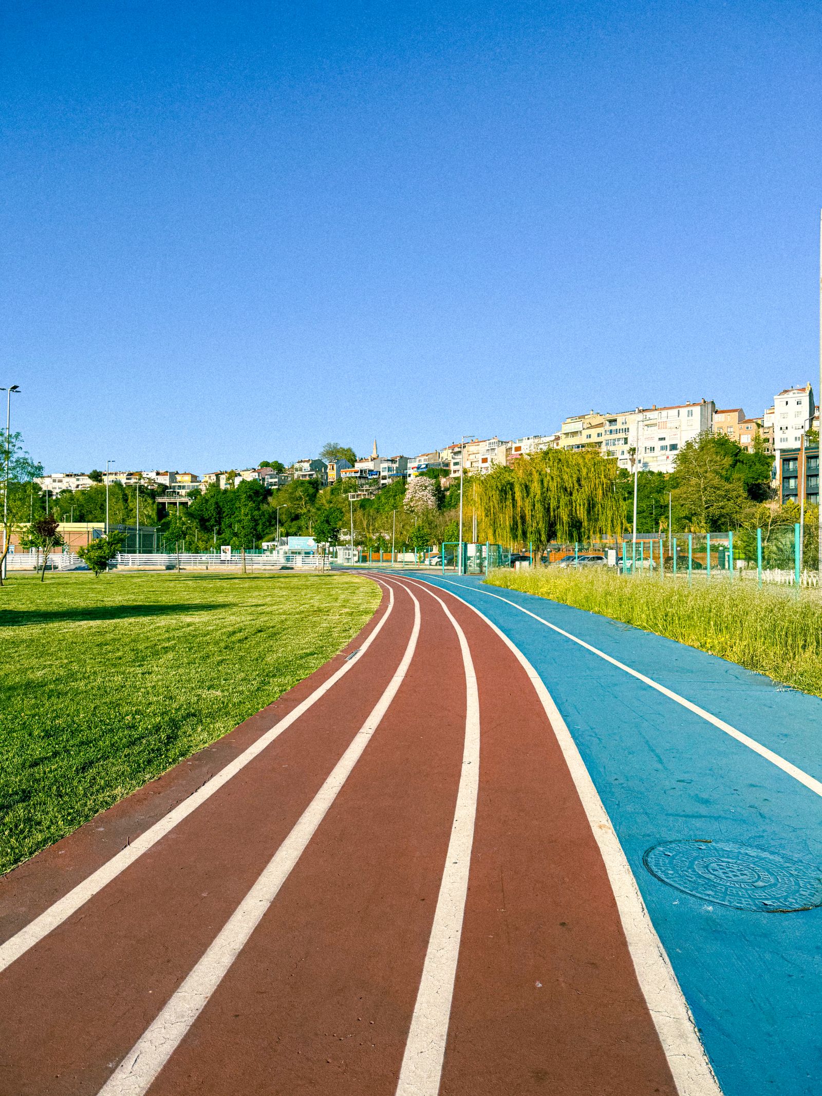 Running track through green parkland